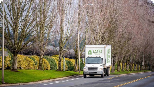 Later Neighbor Moving Truck driving on a highway